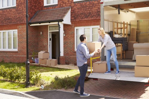 Man with van loading furniture in Isleworth residential street