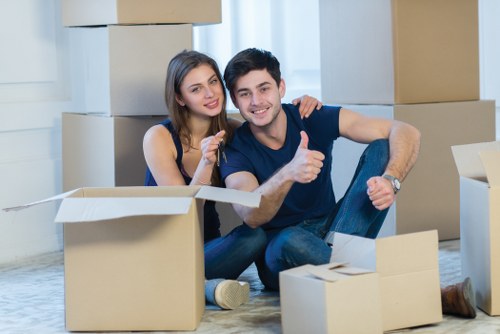 Professional movers handling household items in a West London property